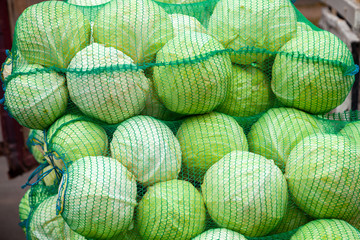 White cabbage in bags at the market.