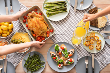 Friends having dinner at table, top view