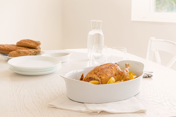 Baking dish with tasty chicken and potato served on table
