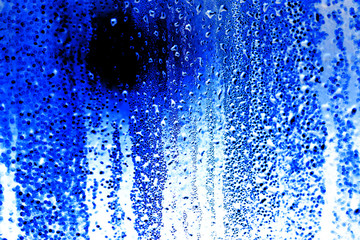 Drops on glass on a blue background