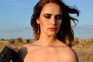 Naklejka premium beautiful girl in the steppe close up