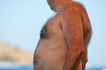 Hair on the chest and abdomen in a man
