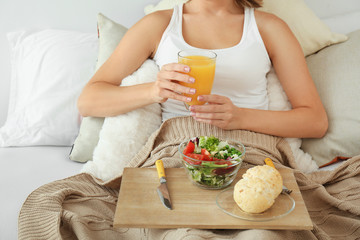 Obraz na płótnie Canvas Woman having tasty breakfast in bed