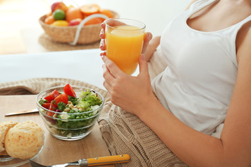 Woman having tasty breakfast in bed