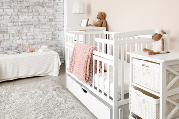 Interior of stylish children's room with baby bed