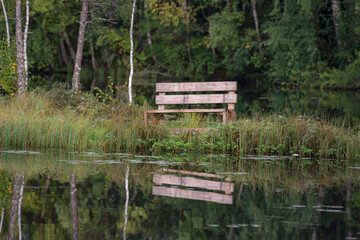Fototapeta na wymiar Wooden bench on the lake