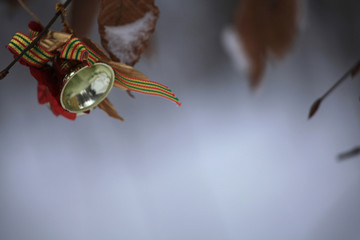 Merry Christmas and Happy New Year 2020. Winter moke-up and festive background in the forest outdoors with a Christmas bell on a tree