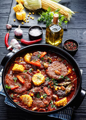 Burgers in marinara sauce with corn cobs