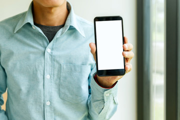 Man holding smartphone in hand. Business man showing smartphone.