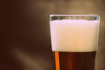 Glass with a light beer closeup in retro style