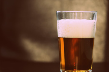 Glass with a light beer closeup in retro style
