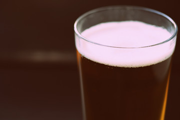 Glass with a light beer closeup in retro style