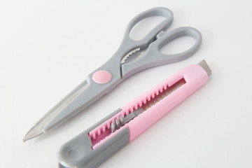 Gray scissors and a stationery knife