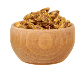 Crispy granola, dried fruits with grains. Wooden bowl.