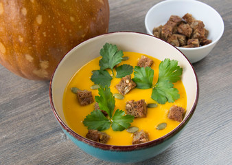 Pumpkin cream soup with pumpkin seeds and parsley