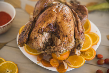 Baked chicken with oranges on light table