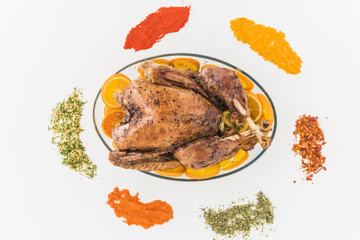 Baked chicken with flavourings on table