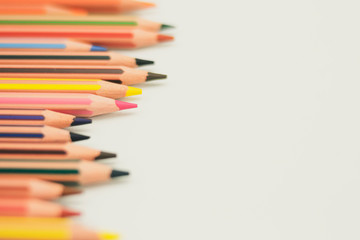 Colored pencils from the left, well sharpened, on white background