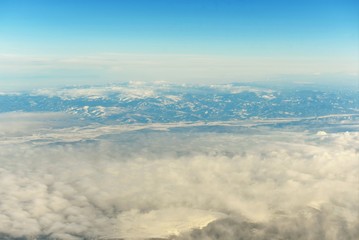 White clouds took shape above during the flight on the plane