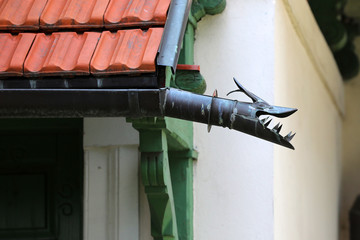 Decorative gutter end in the shape of a dragon's head