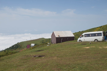 Summer evening mountain village outskirts with wooden shed. Gomi mountain village