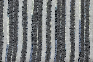 Background in the form of knitted material with alternating vertical light and dark stripes