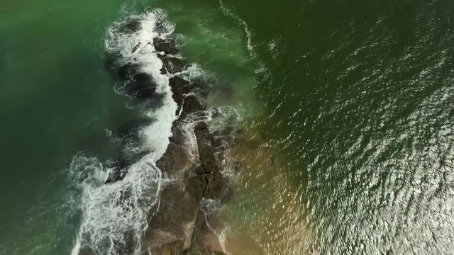 This is the beach of Gunga, in Brazil. There is a rock formation that stops the waves from coming to the beach.