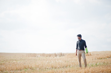 South asian agronomist farmer inspecting wheat field farm. Agriculture production concept.