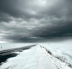 Stormy sky and snow road