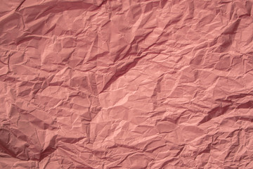 Red crumpled paper close up texture background