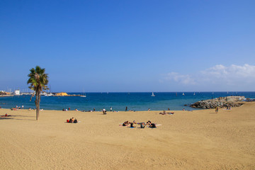 The beach of Barcelona with sailboats and people, Catalonia - Spain