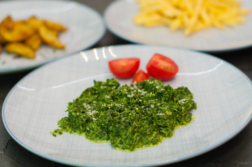 Braised spinach with cheese and tomatoes. Vegetarian food, side dish or appetizer.
