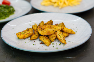 Fried potatoes with spices. Vegetarian food side dish or appetizer.