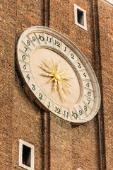 Fototapeta na wymiar Venice, closeup of the bell tower of the Church of the Santi Apostoli (Holy Apostles), with the clock face, UNESCO world heritage site, Veneto, italy, Europe