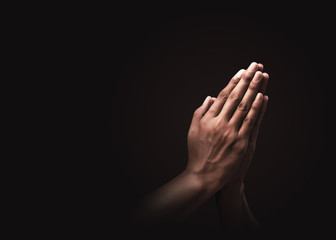 Praying hands with faith in religion and belief in God on dark background. Power of hope or love and devotion. Namaste or Namaskar hands gesture. Prayer position. - obrazy, fototapety, plakaty
