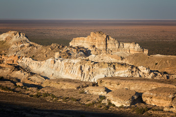 Beautiful cliffs in the canyon of the Ustyurt plateau, lit by the sun at sunset, Uzbekistan