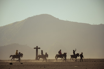Fototapeta premium Horse riding in the dust, horsemen riding in sandstorm, Sand dune, desert