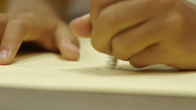woman erases the lettering on the paper