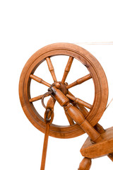 Closeup of the wheel of old spinning wheel isolated on a white background. Very old wheel and spokes of a hand crafted spinning wheel made from natural wood. Historical working tool. Isolated