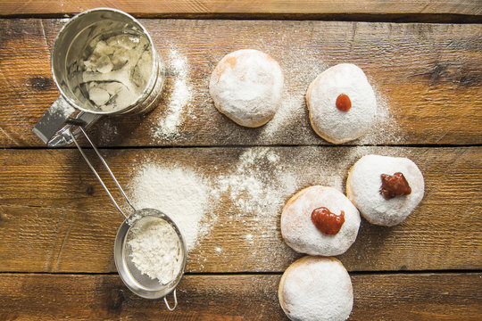 Utensils lying near dougnuts