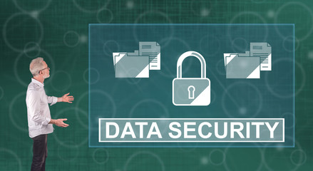 A data security concept explained by a businessman on a wall screen