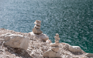 man sitting on a rock and looking at the sea