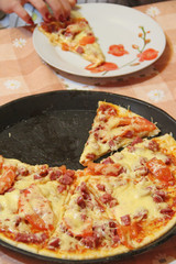 Slices of fresh appetizing pizza with delicious ingredients on plate