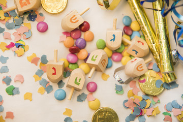 Fototapeta na wymiar Dreidels on confetti and candies