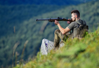soldier in the field. combat readiness. muscular man hold weapon. purpose and success. military style. male in camouflage. army forces. sniper reach target mountain. man ready to fire. hunter hobby