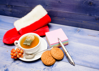 Ceramic cup hot fresh brewed tea beverage. Cup of tea on blue background close up. Gourmet delicious taste. Berry tea. Warm beverage. Drink aromatic rowanberry beverage. Health care folk remedies