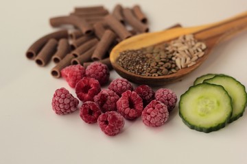 Sample foods from low-GI PCOS (Polycystic Ovary Syndrome) diet. Lentils, chia seeds, sunflower seeds, buckwheat pasta, raspberries and cucumber. 