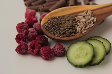 Sample foods from low-GI PCOS (Polycystic Ovary Syndrome) diet. Lentils, chia seeds, sunflower seeds, buckwheat pasta, raspberries and cucumber. 