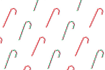 Green and red candy canes pattern isolated on white, top view.