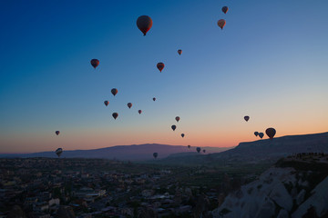 Sunrise panoramic view to Goreme city and flying balloons, Cappadocia, Turkey